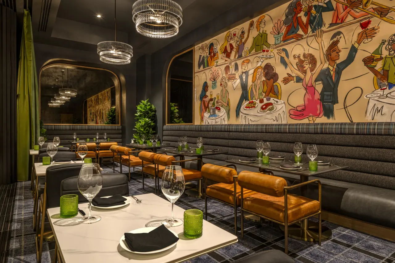 The dining room with leather chairs and a painted mural
