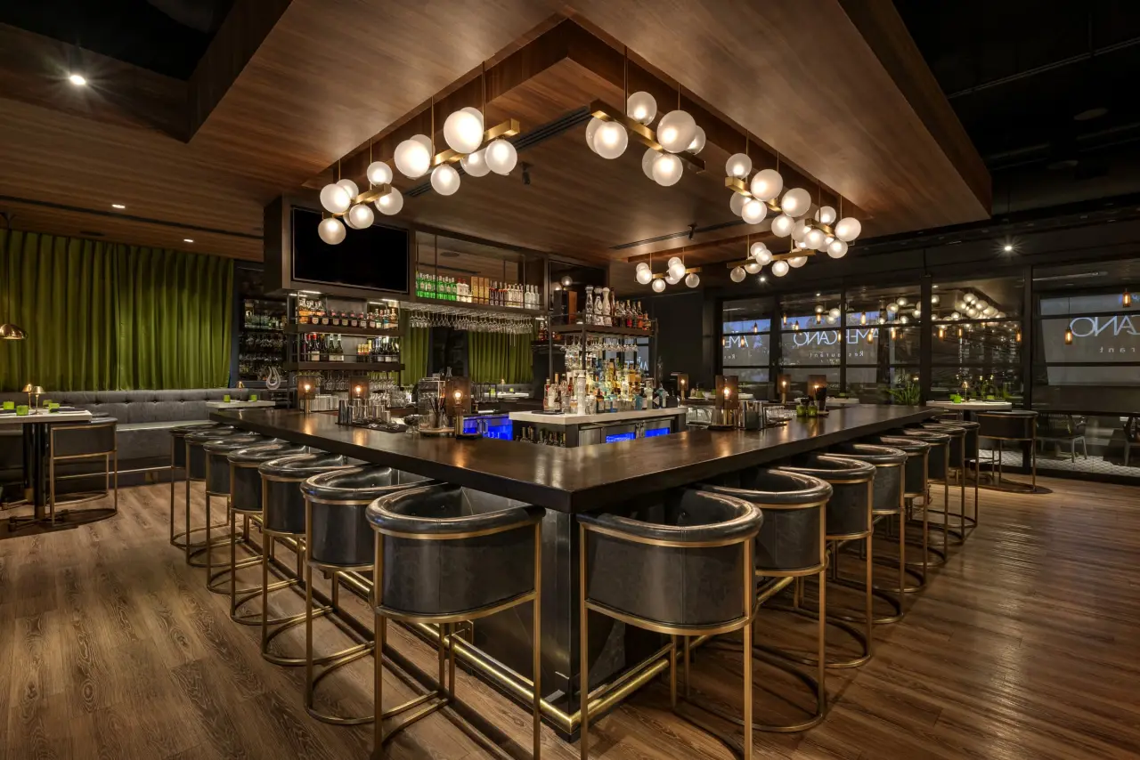 The bar at The Americano under globe pendant lights